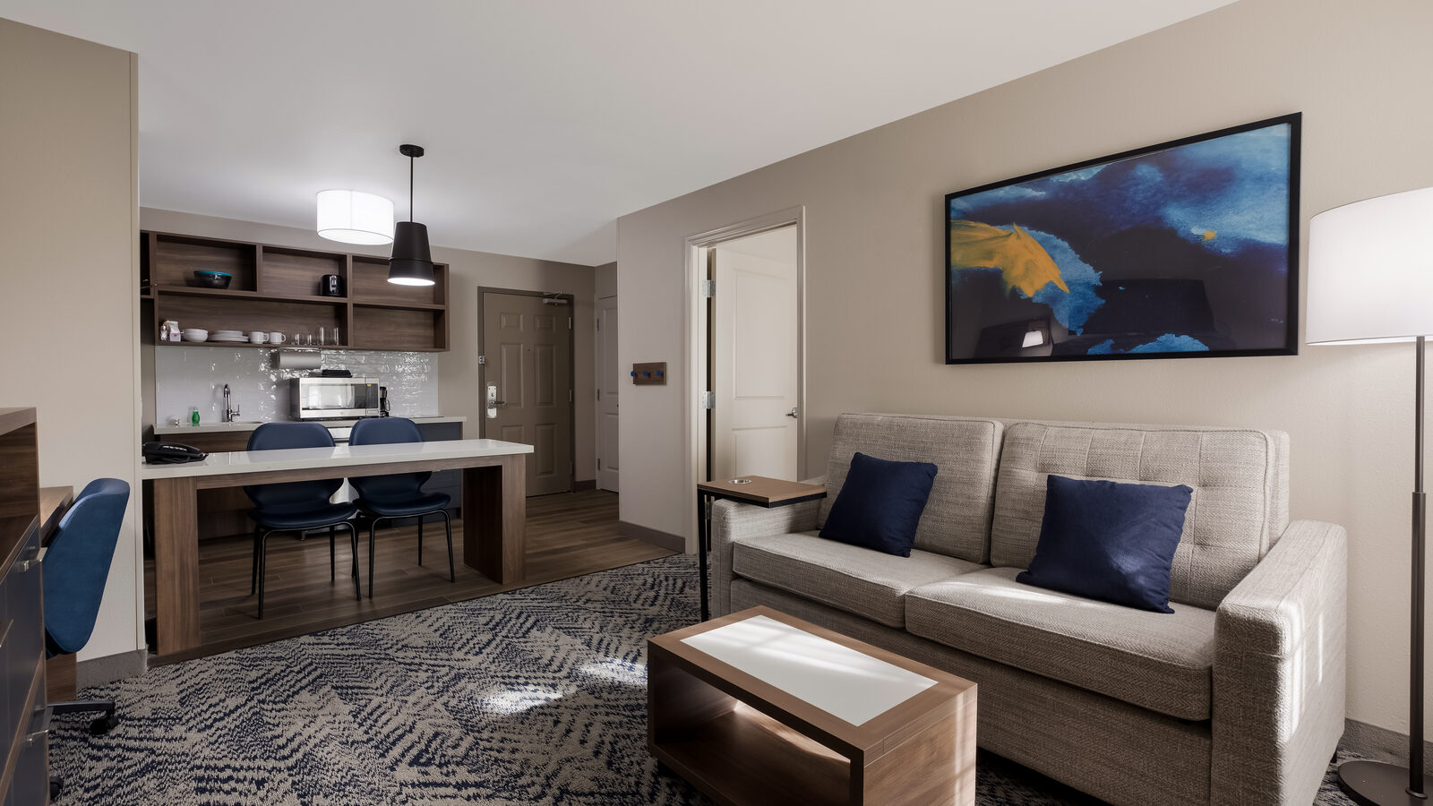 Living room suite with sofa and dining area at Candlewood Suites Lafayette – River Ranch